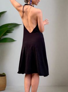 Simple black flowing dress. If we were to transform our favorite pair of black glorkapants into the dress - this would be it! Simple stretchy black dress that fits most sizes, and has two adjustable straps (you can tighten them up behind the neck and pull them lower if you want a deeper opening, or higher if you want more of the sporty look). This dress is a perfect everyday wear, as well as a cute going-out outfit. We danced in it, we meditated, did sun salutations and sat for a sound bath. We played with the belt, wrapping it around in different ways each time creating a different look! We love it! Try it out and play with it! Material: Cotton jersey (90% cotton 10 lycra). Very smooth and breathable. The dress is being handmade in two of our studios in New York and Los Angeles. Size: One Stretch Halter Neck Slip Dress For Night Out, Black Stretch Dress With Built-in Bra, Black Dress With Spaghetti Straps And Built-in Bra, Black Spaghetti Strap Dress With Built-in Bra, Black Stretch Backless Dress With Low Back, Black V-neck Suspender Dress For Night Out, Black Suspender Dress With Built-in Bra, Black Halter Dress With Back Opening For Summer, Black Fitted Suspender Dress Sundress