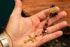 This elegant handmade rosary is made of gold wire and 8mm purple glass beads. Features a gold-finished crucifix and Marian medal. Handmade Rosary, Purple Beads, Purple Glass, Gold Wire, Prayer Beads, Rosary, Bead Charms, Glass Beads, Accessory Gift