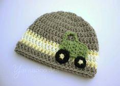 a crocheted hat with a green tractor on it