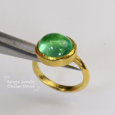 This designer J.Hengen ring features a glowing green beryl cabochon set in 18k solid gold. Ring Size: 6.75 Total Weight: 11.78 grams Precious Metal: 18k solid gold Precious stones: -Green Beryl Center Stone: 12 carats, 15mm x 13mm Hallmark: J Green Cabochon Dome Ring For Formal Occasions, Modern Round Cabochon Emerald Ring, Modern Yellow Gold Emerald Cabochon Ring, Gold Emerald Cabochon Ring For May Birthstone, Estate Ring, Estate Rings, Platinum Diamond Rings, Solid Gold Ring, Diamond Cocktail Rings