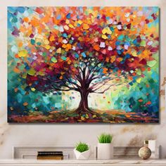 an abstract painting on the wall of a living room with a large tree and colorful leaves