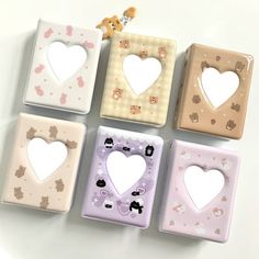 four square shaped magnets with hearts on the front and one heart in the middle