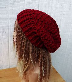 a close up of a mannequin's head wearing a red knitted hat