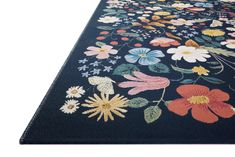 a black rug with colorful flowers on it