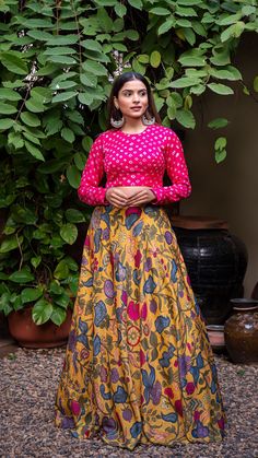 Mustard Yellow soft silk printed lehenga set comes with closed neck bandhani blouse in pink color which features full sleeves and closed back with hook-eye opening. Color of Lehenga - Mustard Yellow. Color of Crop Top - Pink. Fabric of Lehenga- Printed Soft Silk. Fabric of Crop Top - Modal Silk. Number of components - 2. Measurements in the size chart are all garment measurements. The actual print-placement of the product may vary slightly from the image shown. Standard Lehenga Length - 43". Sta Pink Block Print Saree Sets, Pink Unstitched Lehenga With Printed Motifs, Pink Anarkali Set With Kalamkari Print, Pink Lehenga With Printed Motifs, Art Silk Choli With Printed Motifs For Festivals, Semi-stitched Art Silk Choli With Printed Motifs, Diwali Long Sleeve Bandhani Print Anarkali Set, Pink Block Print Traditional Wear For Navratri, Pink Semi-stitched Block Print Traditional Wear