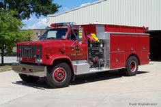 a red fire truck parked in front of a building