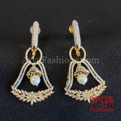 Zara Victorian Golden CZ Party Earrings Party/Trendy/Silver Cubic Zirconia Earrings/Ethnic earrings/American Diamond Earrings 1-Made in Brass 2-Length: 2.25 Inches 3-Available in Victorian and Golden finish 4- Made with very high quality CZ Stones 5- Lightweight Jewelry 6- Suitable for any traditional or contemporary occasion 7-Very Elegant and stylish, suitable for any attire. 8- Comes with push back closure Party Pearl Earrings With Cubic Zirconia, White Cubic Zirconia Party Earrings, White Crystal Earrings With Elegant Design For Party, American Diamond Drop Earrings For Party, Festive Party Pearl Earrings, Festive White Cubic Zirconia Earrings, American Diamond Chandelier Earrings For Party, Dazzling American Diamond Earrings For Party, White Elegant Earrings For Party