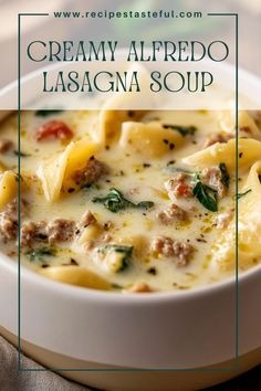 creamy alfredo lasagna soup with sausage and spinach in a white bowl on a table