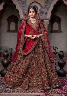 a woman in a red and gold bridal gown