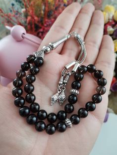 ✔️ This top quality dark black tasbih is made of 8 mm round cut smoky quartz beads. ✔️ It is a premium quality and striking natural stone tesbih. ✔️ Natural color rosary ✔️ Natural AAA Smoky Quartz Stone ✔️ Each order comes in a special free gift box. ✔️ PLEASE CLICK THE LINK FOR ALL PRAYER BEADS MODELS https://www.etsy.com/shop/GoodJewelsofYazmasal Note: As a natural feature the stones beads may have some variations. SHIPPING: United States (Standart/DHL eCommerce/usps): 7-10 business days Unit Traditional Black Beads For Gift, Handmade Black Spiritual Beads, Handmade Spiritual Black Beads, Black 8mm Beads For Gifts, Spiritual Black Beads For Jewelry Making, Black Hand-strung Beads For Jewelry Making, Black Hand-strung Beads As Gift, Black Hand-strung Beads Gift, Traditional Black Rosary With 8mm Beads