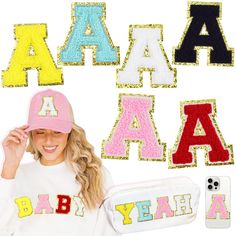 a woman wearing a pink hat standing in front of letters that spell out the word baby