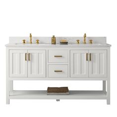 a white bathroom vanity with two sinks and gold faucets on the countertop