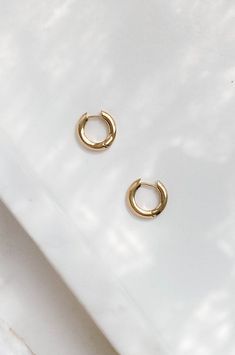 The chic huggie hoop are dipped in 14k gold and are hypoallergenic. They feature a minimalistic semi-thick round circle hoop. #huggiehoops #huggiecharm #huggies #huggieearrings #14karatgold #huggiechainearrings #huggieearrings #14kgoldhuggie #14kgoldhuggiehoops #14kgoldhuggieearrings #14kgoldearrings ##huggiehoops #daintyhoops #simplehoops #modernhoops #hypoallergenicjewelry #hypoallergenicearrings #stylelookbook #chictrends #chicstyle #chicjewelry #tumblrstyle Minimalist 14k Gold Filled Huggie Earrings, Simple 14k Gold Huggie Earrings For Everyday, Trendy Hypoallergenic Round Huggie Earrings, Trendy Hypoallergenic Huggie Earrings, Gold Round Huggie Earrings In 14k Gold Filled, Trendy Gold Round Huggie Earrings, Rose Gold Small Hoop Huggie Earrings For Everyday, Tarnish Resistant Hoop Earrings, Everyday Tarnish Resistant Hoop Earrings