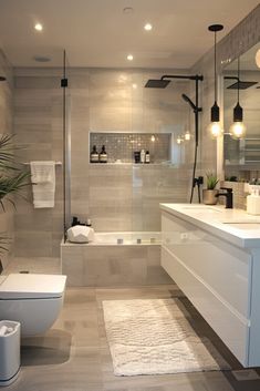 a bathroom with a toilet, sink and bathtub