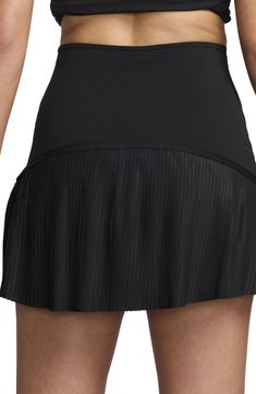 Take to the courts with confidence in this moisture-wicking miniskirt featuring a pleated hem, built-in shorts and handy pockets to hold your essentials. 15" length; 4" inseam; 16" leg opening (size Medium) Elastic waist Dri-FIT moisture-wicking technology Drop-in pockets Built-in shorts Stretch lining 78% polyester, 22% spandex Machine wash, line dry Imported Black Mini Tennis Skirt With Built-in Shorts, Fitted Mini Skirt For Tennis, Sporty Pleated Short Skort, Pleated Skirted Sports Bottoms, Fitted Short Tennis Dress With Pleated Skirt, Fitted Short Pleated Tennis Dress, Sporty Pleated Skirted Shorts, Sporty Black Tennis Shorts, Sporty Pleated Skirted Bottoms