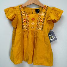 Nwt Lovely Babydoll Top, Linen Look. Flowy With Ruffled Cap Sleeves. True Color Is Rich Egg Yolk Yellow: Leans Mustard In Some Light And Sunflower Yellow In Others. Embroidery In Pattern Of Geometric Angles And Flowers In Red, Black, White, And Ochre. Never Worn, Washed. Stored Well. Smoke Free, One Non-Shedding Dog Home. Same/Next Day Shipping. Bundle Offers Welcomed. Cute Yellow Fitted Blouse, Summer Flutter Sleeve Tops For Playtime, Cotton Flutter Sleeve Tops For Playtime, Yellow Spring Tops For Playwear, Yellow Tops For Spring Playwear, Cotton Tops With Flutter Sleeves For Playtime, Fitted Yellow Tops For Playtime, Embroidered Summer Tops For Playtime, Embroidered Cotton Top For Playtime