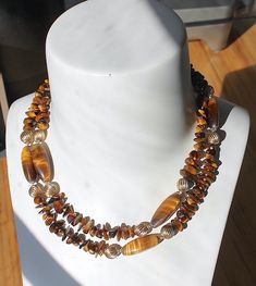 "Vintage Single Strand, Richly Golden, Genuine Tigers Eye - Semi Precious Gemstone Necklace Signed:  No Circa: 1970's This is a stunning piece of \"lapidist craft\" genuine Tigers Eye-Semi Precious Gemstone vintage necklace. The thread is cotton with a combination of polished 3 sided stones and polished chips interspersed by Spiralled Golden Sphere spacers. Each main stone is a highly polished 3 sided ovaloid shaped piece. The clasp is a strong screw barrel. The weight is 83 grams, length 93 cms Vintage Double Strand Gemstone Bead Jewelry, Vintage Double Strand Gemstone Beads Necklace, Wedding Jewellery Necklace, Tigers Eye, Wedding Necklace, Semi Precious Gemstones, Tiger Eye, Gemstone Necklace, Vintage Necklace