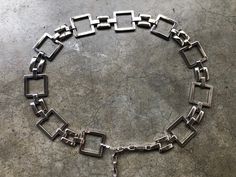 "St. John chunky silver tone square link belt. Total length 41.5\" Length of main chain:32.5\" Length of tail chain: 8\" Recommended for 33\"-38\" waist/hip. Can fit smaller if clipped on to main decorative chain. About 1 5/8\" wide" Vintage Silver Adjustable Chain Belt, Vintage Silver Square Jewelry, Silver Rectangular Metal Chain Necklace, Silver Chunky Chain Rectangular Necklace, Silver Chunky Chain Necklace Rectangular, Silver Rectangular Chunky Chain Necklace, Silver Rectangular Chain Necklace, Chunky Chain Link Metal Belt, Metal Chunky Chain Link Belt