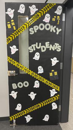 a door decorated with yellow and black tape that says spooky students