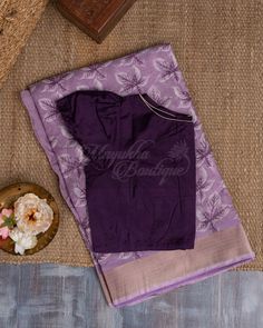 A Saree That Is Gorgeous In Lavender And Features Chanderi Block Printing Would Be A Classy And Striking Alternative. The Soft Glossy Tone With Floral Prints, When Combined With A Kaddi Border And A Pallu Embellished With Flower Patterns, Would Give The Saree A Delicate And Elegant Look. A Stylish Purple Contrast Blouse Is Worn With It. Lavender And Purple Outfit, Lavender Colour Saree Contrast Blouse, Purple Colour Combinations Saree, Lavendar Saree Contrast Blouse Ideas, Brinjal Colour Saree Contrast Blouse, Purple Colour Saree Contrast Blouse, Purple Unstitched Blouse In Cotton Silk Traditional Wear, Festive Unstitched Lavender Blouse Piece, Traditional Lavender Unstitched Blouse Piece