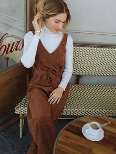 The Sleeveless Belted Jumpsuit is a fun and stylish way to add some flare to your wardrobe. This jumpsuit features a lined top, an unlined bottom, and a waist belt for an adjustable fit. The corduroy fabric is soft yet durable and comes in a variety of colors for you to choose from. It has four buttons along the straps for added detail as well as two pockets at the sides for extra convenience. With its comfortable fit and trendy look, this overall jumpsuit is perfect for any occasion! Specifications: Pattern Type: Plain Length: Long Fit Type: Regular Fit Neckline: Straps Sleeve Length: Sleeveless Waist Line: High Waist Composition: 100% Polyester Care Instructions: Machine wash or professional dry clean Belt: Yes Size Chart: Size US Bust Hip Size Inseam Length Thigh Waist Size XS 2 96 102 Trendy Belted Jumpsuit For Fall, Trendy Belted Jumpsuits And Rompers For Fall, Brown Sleeveless Overalls For Spring, Sleeveless Brown Overalls For Spring, Trendy Sleeveless Jumpsuits And Rompers For Fall, Jumpsuit With Sweater, Jumpsuit Winter Outfit, Nashville Outfit, Corduroy Overall