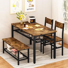 a wooden table with two benches and a potted plant