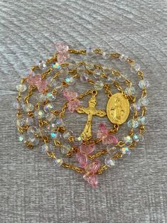 Handcrafted Prayer Rosary. Pink Butterfly Beads, Clear Crystals, Gold Crucifix and Virgin Mary Medallion. Butterfly Garden Crystal Rosary. - Etsy Gold Beaded Rosary Bracelet With Cross Shape, Gold Handmade Cross Rosary Bracelet, Gold Beaded Crucifix Rosary, Vintage Gold Rosary As Gift, Gold Crucifix Rosary For Jewelry Making, Gold Spiritual Rosary For First Communion, Gold Beaded Crucifix Jewelry, Romans 12 21, Crystal Rosary