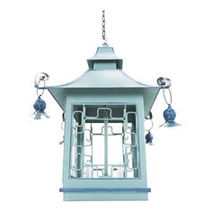 a blue bird feeder with bells hanging from it's side on a white background