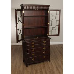 an antique dresser with mirrored doors and drawers