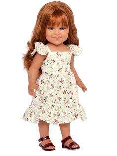 a doll with red hair wearing a white dress and brown sandals, standing in front of a