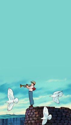 a man standing on top of a brick wall with birds flying around him and holding a trumpet