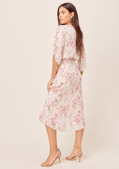 Bring on the romance in our dreamy floral print midi faux wrap dress. Featuring flirty tulip sleeves, a smocked elastic waist for definition, and feminine ruffle details. The soft watercolor brush strokes in the pink and cream floral print adds a sweet touch, while the subtle metallic details catch the light as you move. FINAL SALE Relaxed fit Elbow-length sleeve Mid-length V-neckline Hook & eye closure Model is 5'10, wearing a size S.Style: I-71882WL-QWO-LL Watercolor Brush Strokes, Soft Watercolor, Tulip Sleeve, Midi Wrap Dress, Elbow Length Sleeve, Cream Dress, Faux Wrap Dress, Floral Midi Dress, Rosemary