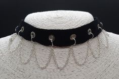 This gothy, punky choker is made from cotton ribbon set with eyelets running along the middle. The silver plated chain hangs in loops from rings attached through the eyelets and sits elegantly on the collar line.  The choker can be adjusted in length using the extender chain.   Allergy Information  I take customer care very seriously and make sure that all my jewellery is Nickel free.  * All items come in gift-wrapped jewellery box free of charge * Gothic Metal Choker For Concerts, Emo Metal Choker For Party, Gothic Chain Choker For Concerts, Silver Emo Choker For Concert, Emo Metal Choker For Festivals, Emo Style Metal Choker For Festivals, Metal Emo Choker For Alternative Fashion, Punk Choker With Adjustable Chain For Festival, Silver Grunge Choker For Concert