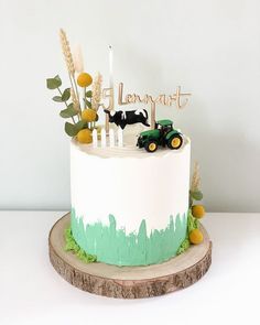 a birthday cake with a tractor and farm animals on it