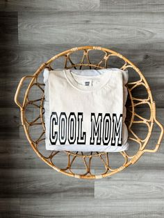 This listing is for ONE "Cool Mom" t-shirt DETAILS Comfort Colors 1717 ☺︎ 6.1-ounce, 100% ring spun cotton     Soft-washed, garment-dyed fabric     Double-needle collar     Twill-taped neck and shoulders     Twill label     Double-needle armhole, sleeve and bottom hems ☺︎ Premium Vinyl SHIRT CARE ☺︎ Machine wash on COLD, inside out, with like colors.  ☺︎ Do NOT bleach ☺︎ Tumble dry at low temperature ☺︎ Do not iron ☺︎ Do not dry clean *Due to the handmade nature of this item, small imperfections may be visible.  Colors may vary due to lighting, computer screen, phone screen or filter. *Our shop is not held accountable for lost, stolen or missing packages.  Please make sure to use correct shipping address.  We can not change shipping address once your package is out for delivery.   *All sal Cotton Slogan T-shirt For Fan Apparel, Cotton Slogan T-shirt For Fans, Cotton Slogan T-shirt Fan Apparel, Cotton Fan Apparel T-shirt With Slogan, Organic Cotton White T-shirt With Slogan, White Organic Cotton T-shirt With Slogan, White Print Cotton T-shirt For Fan Merchandise, Cool Cotton Slogan T-shirt, White Cotton T-shirt With Lettering