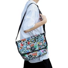 Dive into a world where art meets daily life with the Graffiti Messenger Bag. Celebrating the vibrant and free spirit of street art, this nylon bag is not just a fashion accessory; it's a statement. Each design, carefully curated, resonates with the raw energy of urban landscapes. But it doesn't stop at just making heads turn. One of its standout features is its robustness, ensuring longevity. Celebrate Urban Authenticity with the Graffiti Messenger Bag When you carry the Graffiti Messenger Bag, Casual Black Bags With Graphic Design, Casual Nylon Shoulder Bag For Streetwear, Casual Multicolor Canvas Satchel, Multicolor Rectangular Bags For Streetwear, Urban Canvas School Bag, Casual Shoulder Bag With Graphic Print, Casual Shoulder Bag With Graphic Print For Travel, Casual Shoulder Bag With Graphic Print For Daily Use, Urban Streetwear Bag With Adjustable Strap