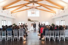 a couple getting married at the end of their wedding ceremony in front of an audience