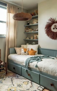 a bedroom with two twin beds and shelves on the wall above them, along with an area rug