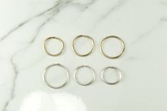 These Hoops are 20  ga sterling silver or gold filled. Modern and Simple  Small and dainty hoop earringswould be great for everyday wear.Handmade and polished to a high shine in my shop.size 10 mm 9 mm 8 mmEarrings are NOT returnable due to hygiene reasons.They are sold in  pairsOuter diameter:  10 mm, 9 mm, 8 mm Simple Nickel-free Round Cartilage Earrings, Nickel-free Round Simple Cartilage Earrings, Simple Round Nickel Free Cartilage Earrings, Simple Round Nickel-free Cartilage Earrings, Dainty Hoop Earrings, Gold Filled Earrings, Silver Band Ring, One Ring, Light Weight Earrings