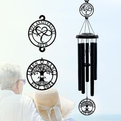 a man sitting next to a wind chime