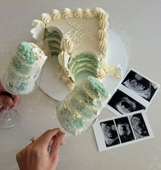 a cake with green frosting and white icing on a table next to photos