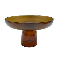 a brown glass bowl sitting on top of a wooden stand with an orange base in the middle