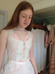 "wonderful antique camisole, with a button and loop front closure. strong valenciennes lace. with a multicolor coral pink silk ribbon bust 78 cm 30,5\" waist 68 cm 26,5\" length 43 cm 17\" in excellent condition" Pink Lace Trim Underbust Corset, Pink Underbust Corset With Lace Trim, Pink Lace Underbust Corset, Pink Lace Corset With Boned Bodice, Pink Lace Wedding Corset, Pink Lace Top For Wedding, Fitted Pink Camisole With Delicate Lace, Vintage Sleeveless Corset With Lace Trim, Vintage Sleeveless Lace Trim Corset