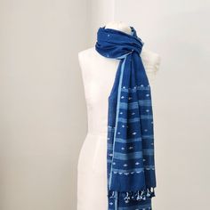 The softest cotton in the deepest indigo blue. Small jamdani-weave details in cotton and raw silk, with ikat-ish stripes at each end. handwoven and naturally dyed cotton with silk details 26.5 x 92 inches Jamdani handloom textiles are woven by hand, by master craftspeople, without the use of electricity. Designs are woven into the fabric while it is on the loom. Each piece is individually hand-crafted. Care: hand wash gently in cool water, line dry in shade. Blue Cotton Handloom Dupatta, Indigo Handloom Cotton Dupatta, Indigo Cotton Handloom Dupatta, Handloom Cotton Indigo Dupatta, Bohemian Indigo Cotton Dupatta, Handloom Cotton Dupatta In Indigo, Traditional Cotton Scarf With Natural Dye, Bohemian Blue Handloom Dupatta, Traditional Cotton Scarves With Natural Dye