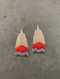 two pairs of beaded earrings with red, white and green fringes on them