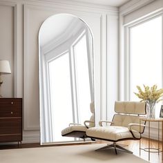 a living room with a chair and large mirror