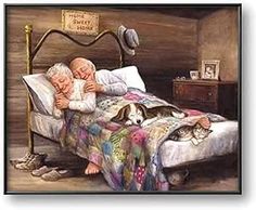 an old man and woman laying in bed with cats