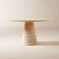 a round table made out of plywood with wavy edges on the top and bottom