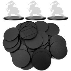 some black round discs are on a white surface