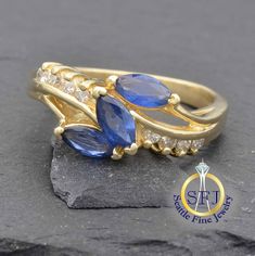 "Restored Vintage Sapphire And Diamond Ring, Solid 14K Yellow Gold METAL: Solid Yellow Gold, Stamped 14K MAIN GEM: Natural Sapphires -- 3 Marquise ACCENT GEMS: Diamonds -- 8 Round CURRENT RING SIZE:  6. (Expert resizing service available. Safe resize range for this ring: 5--8 1/2. See below to purchase resizing.) APPRAISED VALUE: $2,200 In this freeform design, 3 vibrant blue, marquise cut natural sapphires totaling nearly 3/4 carat are arrayed in a diagonal golden swoop.  Meeting them in the mi Yellow Gold Multi-stone Jewelry For Anniversary, Anniversary Multi-stone Yellow Gold Jewelry, Exquisite Gold Sapphire Ring With Prong Setting, Marquise Cut Multi-stone Yellow Gold Diamond Ring, Yellow Gold Multi-stone Sapphire Ring For Anniversary, Anniversary Yellow Gold Multi-stone Sapphire Ring, Heirloom Gold Sapphire Cluster Ring, Heirloom Gold Cluster Ring With Sapphire, Classic Multi-stone Marquise Rings